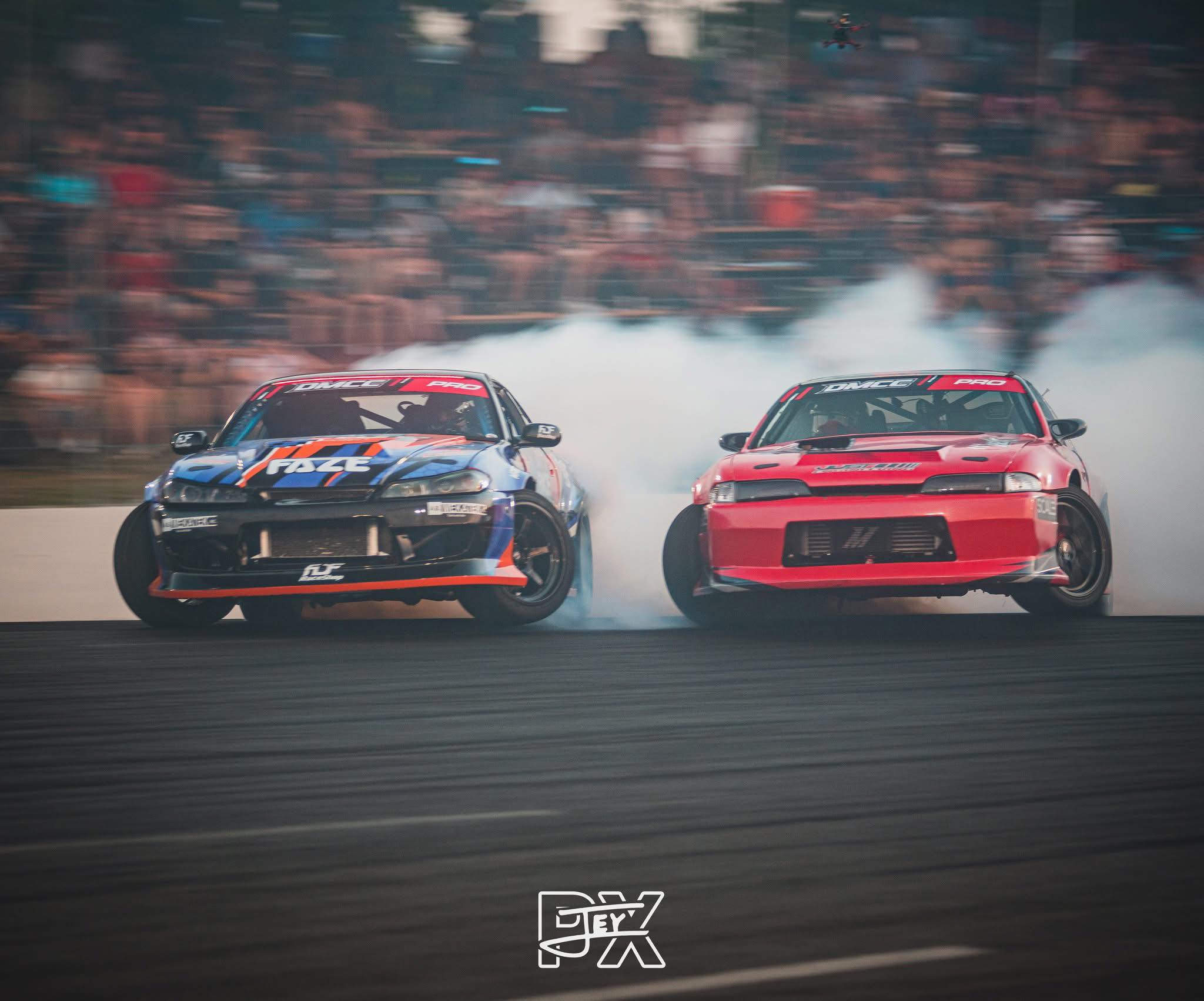 Drift cars running tandem during a competition battle