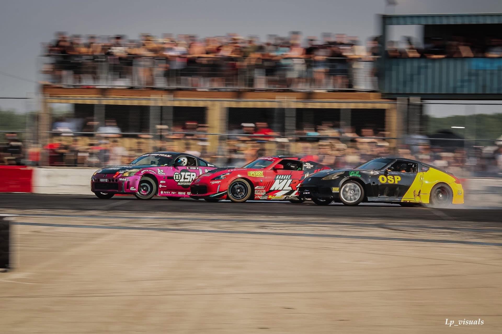 Tandem drift battle at speed in front of spectators
